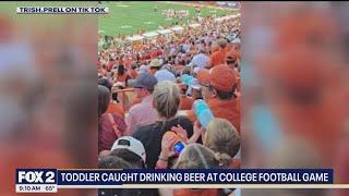 Toddler caught drinking beer at college football game