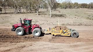 TOOMEY 4000B Scraper behind an STX450 unloading clay onto a water storage wall.