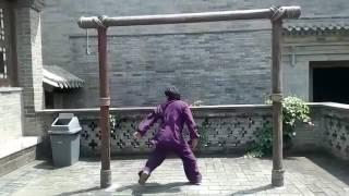 Chinese young martial artist Zhang Guoli is practicing splitting boxing 中国功夫 功夫大师 张国利劈挂拳桩功