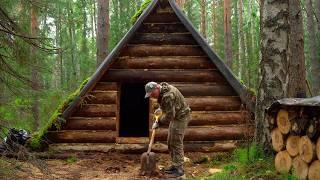 SHELTER FROM BAD WEATHER IN A COZY FOREST CABIN. PREPARING FIREWOOD FOR WINTER.