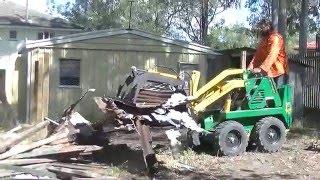 Review our work. Kanga Mini Loader with Log Grapple cleaning up tree stumps and demolition material.