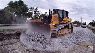 CAT D6XE spreads gravel with grader O&K