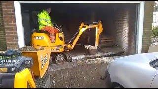 DMS micro digger hire. JCB Micro digger working inside a garage.