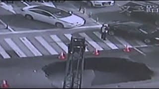 Police Officer Frantically Directs Traffic Around Opening Sinkhole