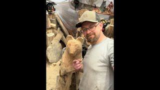 Working on a chainsaw carved bear