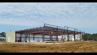 Standing the frame of a red steel building... Day 1