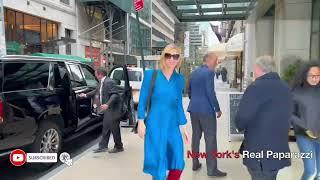 Cate Blanchett looks fabulous in a Blue dress and red boots.