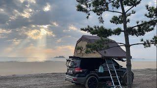 Sea camping at night after work. Mojave rooftop tent. Overland