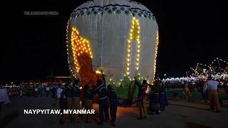 Myanmar briefly forgets deep troubles as giant balloons light up the night skies in annual festival