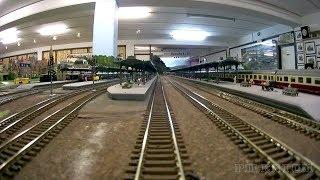 Train cab ride along a never ending model railroad layout in HO scale