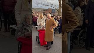 King Charles presents a birthday card to Rona Grafton, who celebrates her 100th birthday today