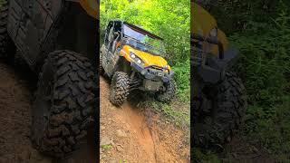 Kawasaki Teryx straddling a washout.