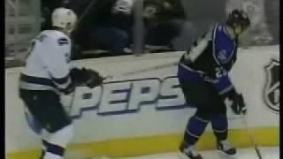 Dustin Brown hits Ohlund and dislodges the glass