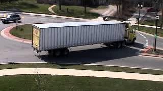 Semi-truck makes U-turn at roundabout