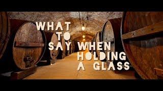 What do Jews say when holding a glass of wine?