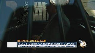 SDSU students corner president in cop car