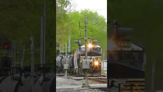 Heavy freight train flies around curve with horns a-blazing