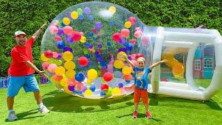 Chris plays with gumball machine and huge inflatable ball