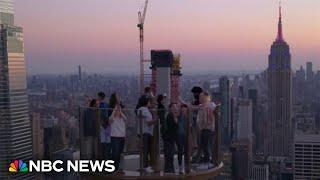 NBC News hosts ride Skylift, an attraction that takes you above Rockefeller Center