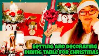 Setting and decorating dining table for Christmas 