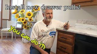 Installing new cabinet drawer pulls. Update the look of your kitchen. Do it yourself and save!