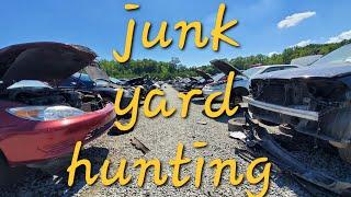 Looking for parts at the pull-a-part junkyard, flipping parts