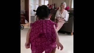 Funny kid imitating her grandmother