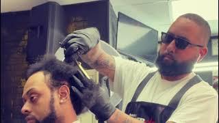 Celebrity Barber “Truth The Barber Artist” gives a haircut to Larry Smoove..