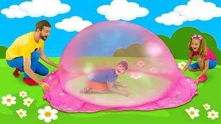 Sasha and Max playing with colorful slime and make huge slime bubble