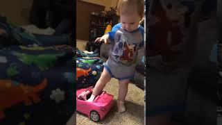 Riley trying to get in a Barbie car