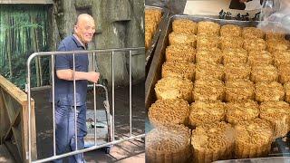 The steamed bread for the pandas is ready. Grandpa Tan pushes a cart to get it.