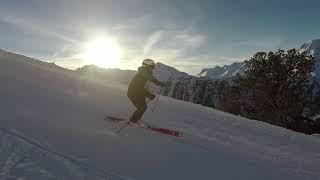 Skiing short turns with a sunset