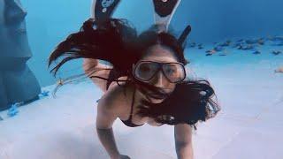 Freediving Girl Looking Around the Pool Facility Underwater