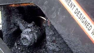 A Paver Placing Base Asphalt - getting it out of the truck onto the road