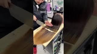 super long hair cut off on chopping board