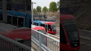 Two Madrid trams depart simultaneously from Colonia Jardín station 