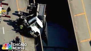 Semi-truck HANGS from overpass, spilling salt on to road and snarling traffic