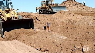 Loaders and bulldozers collaborate together to explore the road.