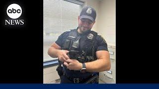 Police officer stops traffic to rescue kitten from road