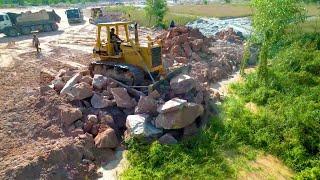 Well Done! strong komatsu dozer pushing big stones landfilling up 25ton trucks dumping stones