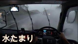 Truck driving on a flooded road.