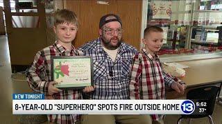 8-year-old "superhero" spots fire outside home