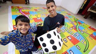 Playing Snakes & Ladder Game  With Brothers