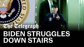 Biden walks slowly down airstairs and pauses several times after Covid diagnosis