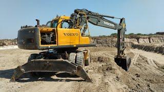 Excavator loading trucks