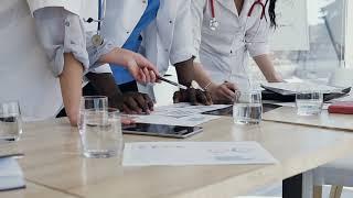 hands of three doctors during discussing result FNS5XZ2