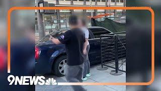 Driver squeezes car through fenced sidewalk, takes off with flat tires