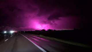 Bright purple sky Ohio turnpike at night