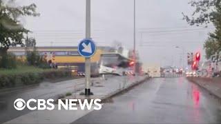 Train slams bus sitting on Dutch railroad crossing