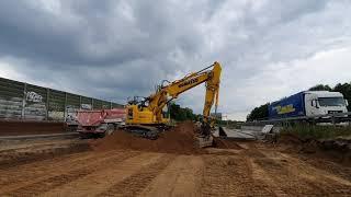 Komatsu PC 228US LC loading sand